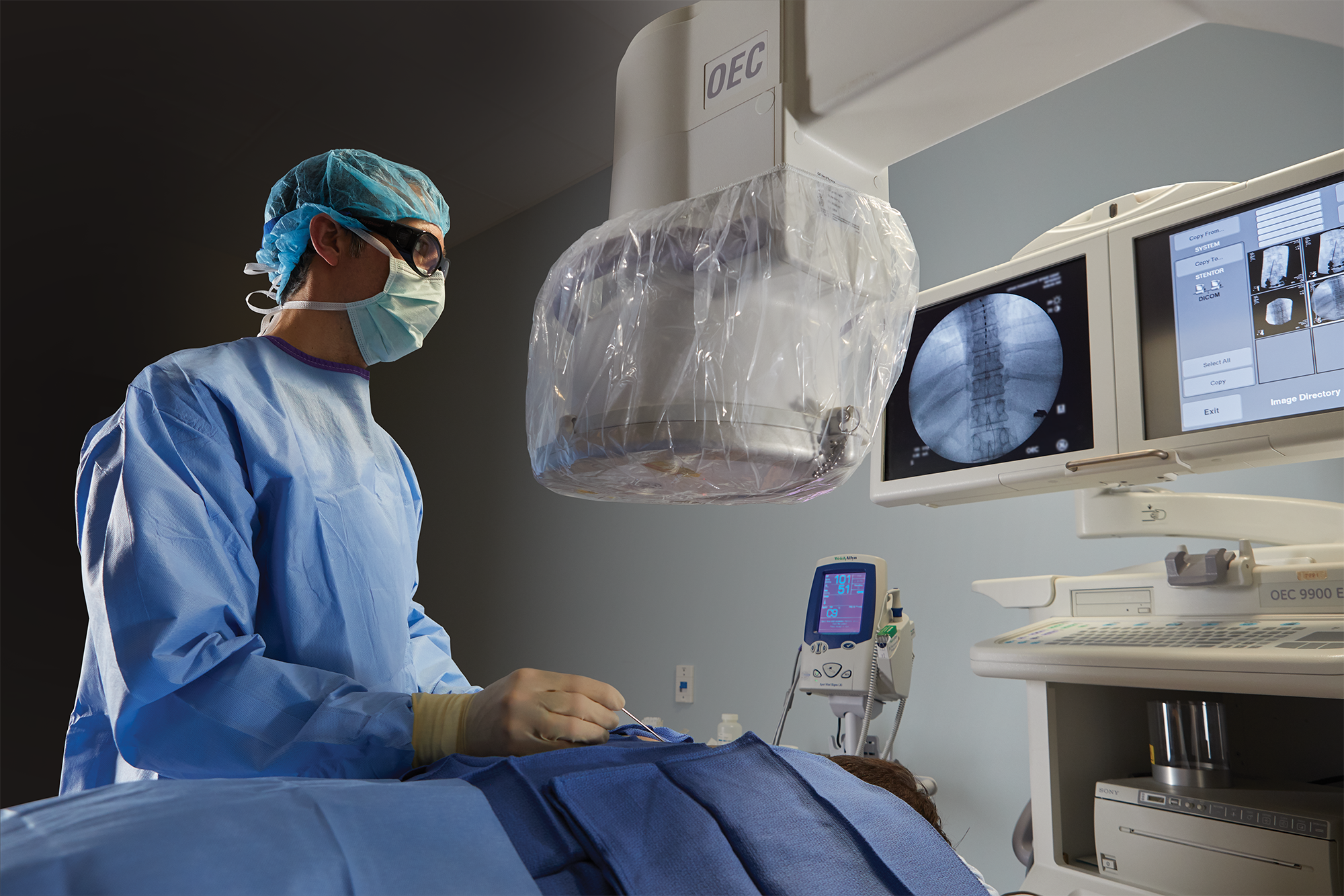 Physician performing procedure on patient spine in an operating room