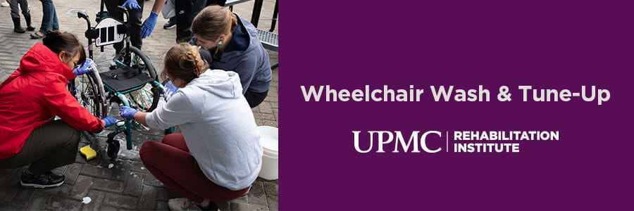 image of three people washing a wheelchair