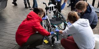 image of three people washing a wheelchair